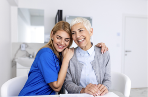 five seniors sitting on a couch embracing each other and smiling in a Pembroke Pines assisted living facility