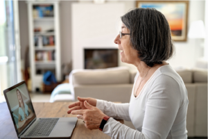 A senior woman using Google Meet to have a video chat with her grandaughter