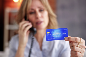 Senior woman reporting financial exploitation to her credit card company